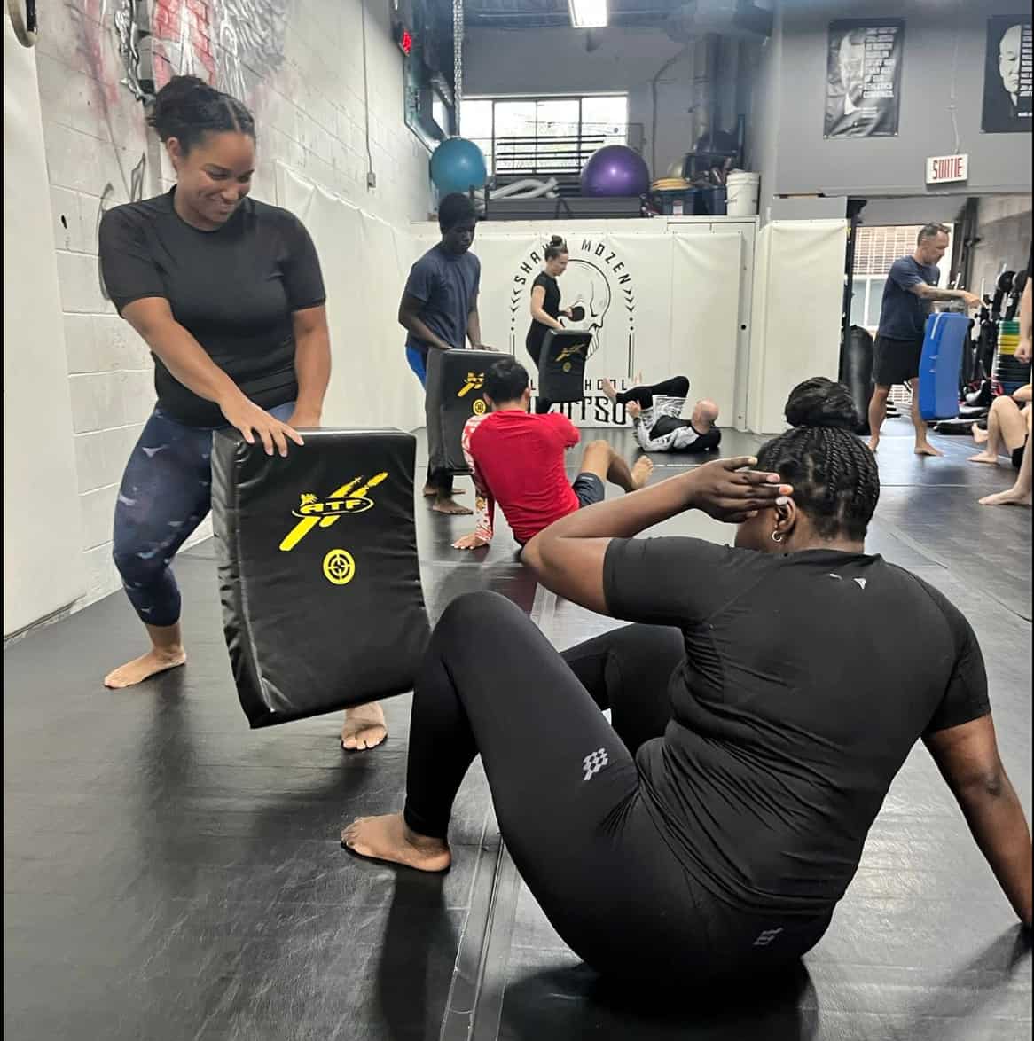 Instructor teaching BJJ technique